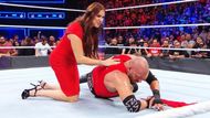 Triple H being helped up by Stephanie McMahon